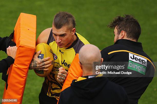 Dustin Martin of the Tigers hits contest bags with the ball during a Richmond Tigers AFL media session at ME Bank Centre on April 12, 2016 in...