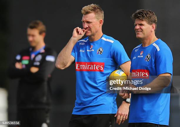 Magpies head coach Nathan Buckley looks on with assistant Robert Harvey during a Collingwood Magpies AFL training session on April 12, 2016 in...