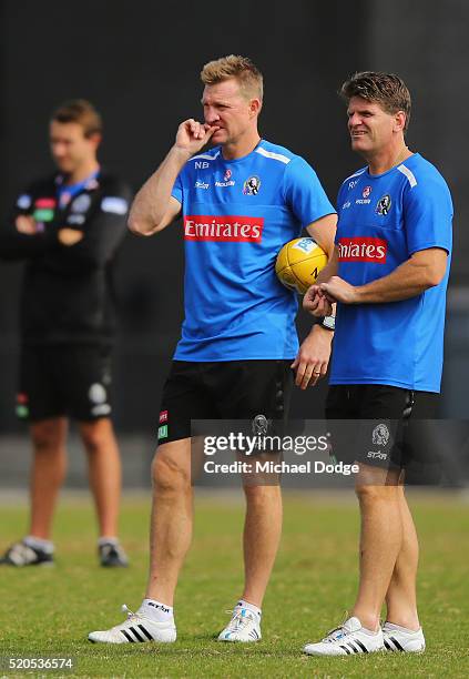 Magpies head coach Nathan Buckley looks on with assistant Robert Harvey during a Collingwood Magpies AFL training session on April 12, 2016 in...