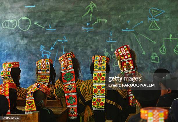 In this photograph taken on October 31 Kalash students attend a class at a school in the Brun village of Bumboret valley. Marriage, for the Kalash,...