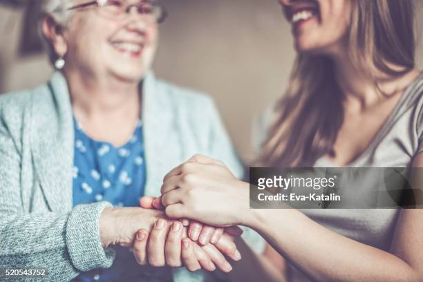 hand in hand - volunteer aged care stock pictures, royalty-free photos & images