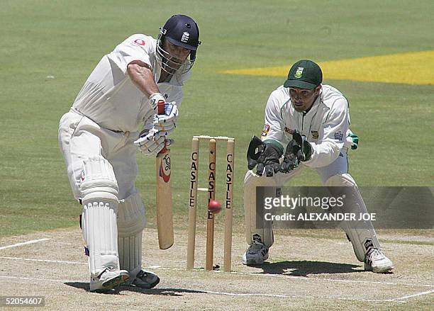 England's Graham Thorpe taps the ball bowled by South African's Andre Nel and Mark Boucher waiting in the background on the fourth day of the fifth...
