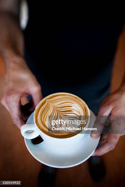 barista holding an espresso drink - seattle coffee stock pictures, royalty-free photos & images