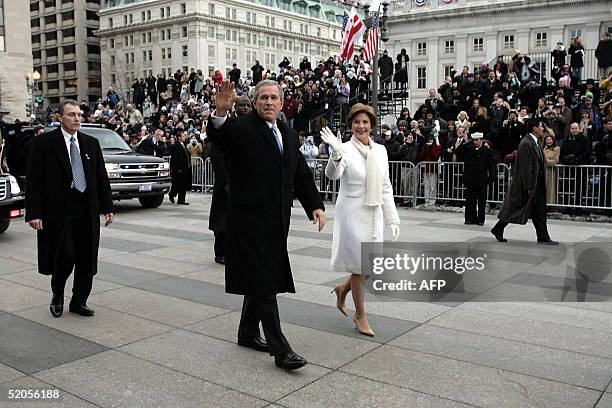 President George W. Bush waves to a cold crowd while walking down Pennsylvania Avenue with First Lady Laura Bush during the Inaugural Parade 20...