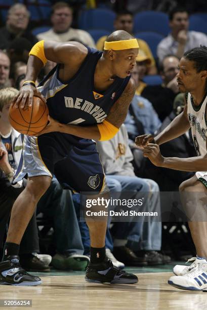 Bonzi Wells of the Memphis Grizzlies looks to play the ball against Latrell Sprewell of the Minnesota Timberwolves during the game at Target Center...