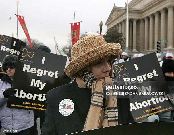 Women carry signs reading "I Regret My Abortion" and sing during the March for Life 24 January 2005 in Washington, DC. Activists marched from the...