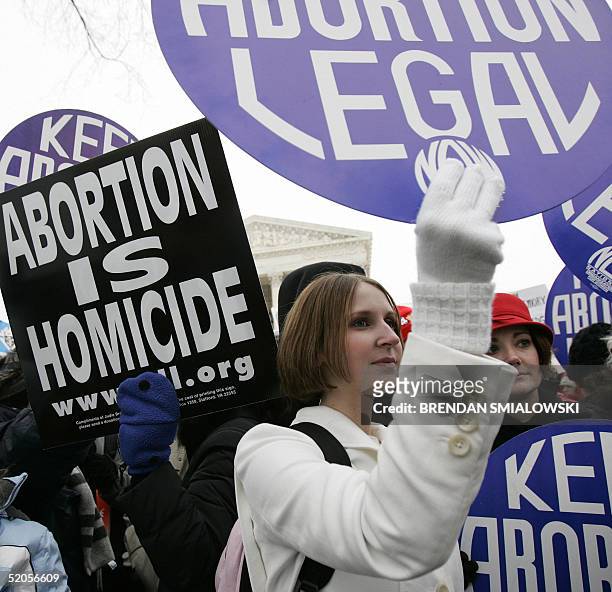 Pro-life and pro-choice activists hold sign during the 'March for Life' outside the US Supreme Court 24 January 2005 in Washington, DC, the 32nd...