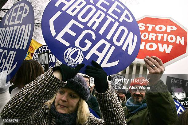 Pro-life activist Bill Rosanelli of Montague, New Jersey, and local pro-choice activist Leanne Libert hold signs outside the U.S. Supreme Court...