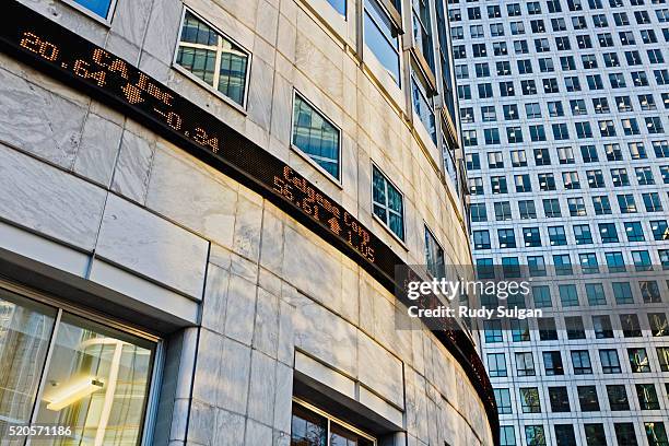 trading ticker on office building at canary wharf - trading screen stock pictures, royalty-free photos & images