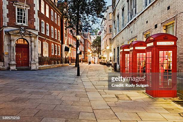 red telephone booths in covent garden - london england stock-fotos und bilder