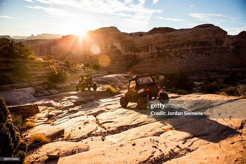 Off road vehicles driving a rock path in Moab.