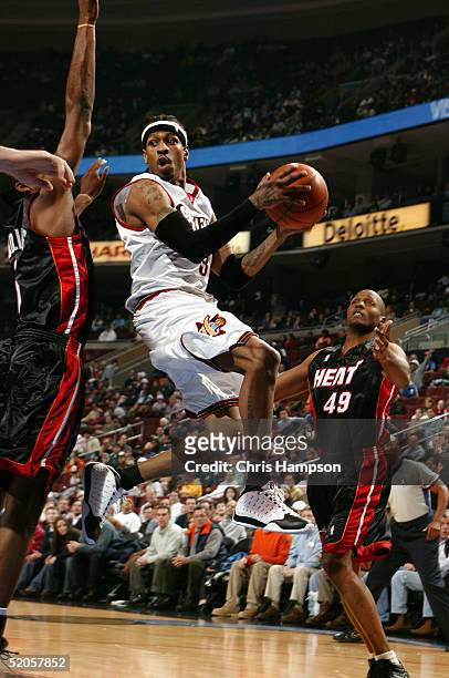 Allen Iverson of the Philadelphia 76ers shoots against the defense of the Miami Heat on January 24, 2005 at the Wachovia Center in Philadelphia,...