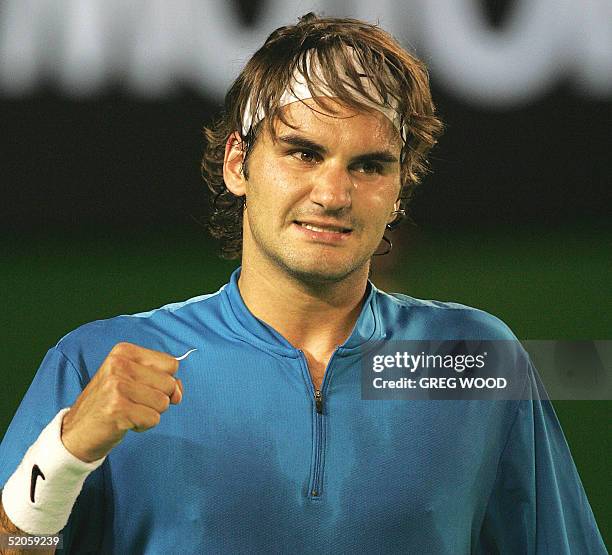 Top seed Roger Federer of Switzerland pumps his fist in celebration after winning the second set against Andre Agassi of the US in their men's...