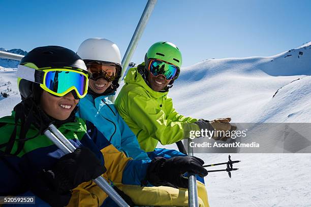family ski vacation - couple ski lift stockfoto's en -beelden