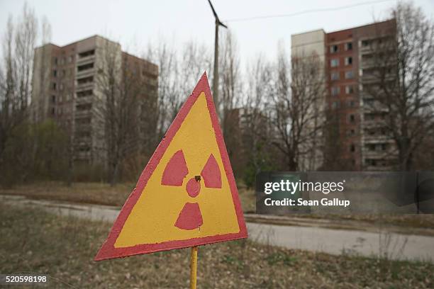 Sign warns of radiation contamination near former apartment buildings on April 9, 2016 in Pripyat, Ukraine. Pripyat, built in the 1970s as a model...