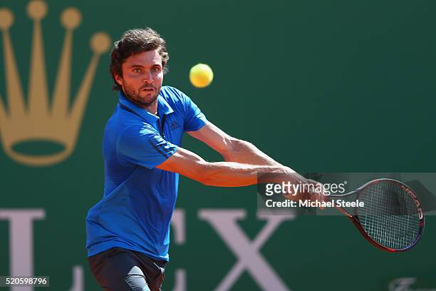 Gilles Simon of France makes a return during his 6-4, 6-3 victory against Grigor Dimitrov of Bulgaria during day three of the Monte Carlo Rolex...
