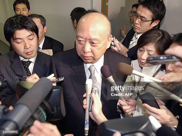 Katsuji Ebisawa , Chairman of Japanese public broadcaster NHK is surrounded by reporters after he met with Taro Aso, Minister of Internal Affairs and...