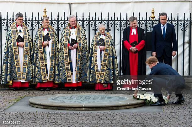 Prime Minister David Cameron looks on as Prince Harry lays a wreath at the service of commemoration for the victims of the 2015 terrorist attacks In...