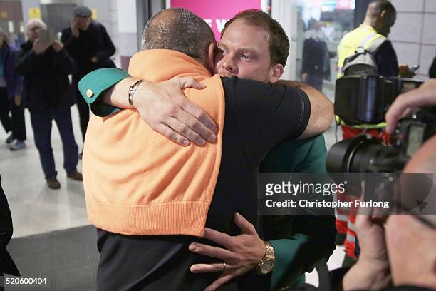 Masters champion Danny Willett is embraced by his manager Andrew Chubby Chandler as they arrive back in the UK at Manchester Airport on April 12,...