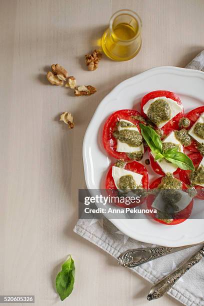 partial view of plate with caprese salad (insalata caprese) - insalata stock-fotos und bilder