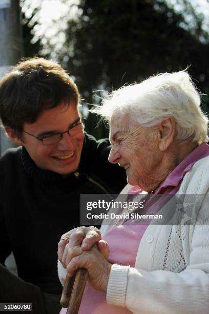 Sebastian Schirrmeister, a 20-year-old German volunteer from Berlin, sits on a park bench with elderly Jewish Holocaust survivor Yanina Brunitzky...