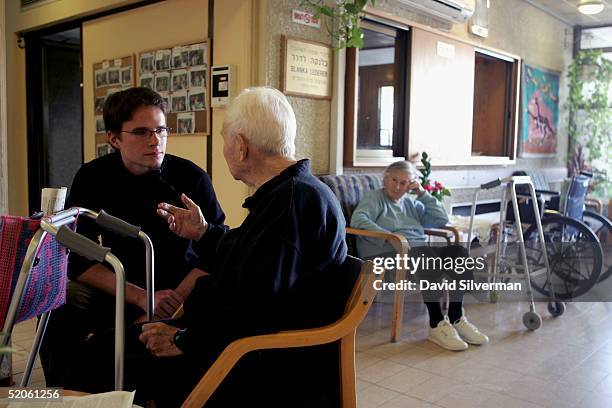 Sebastian Schirrmeister, a 20-year-old German volunteer from Berlin, sits with elderly Jewish Holocaust survivor Dr. Leo Kraus in a retirement home...