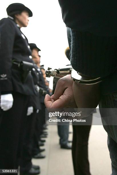 Police parade convicted criminals during a public sentence at a railway station on January 25, 2005 in Chengdu of Sichuan Province, China. The local...