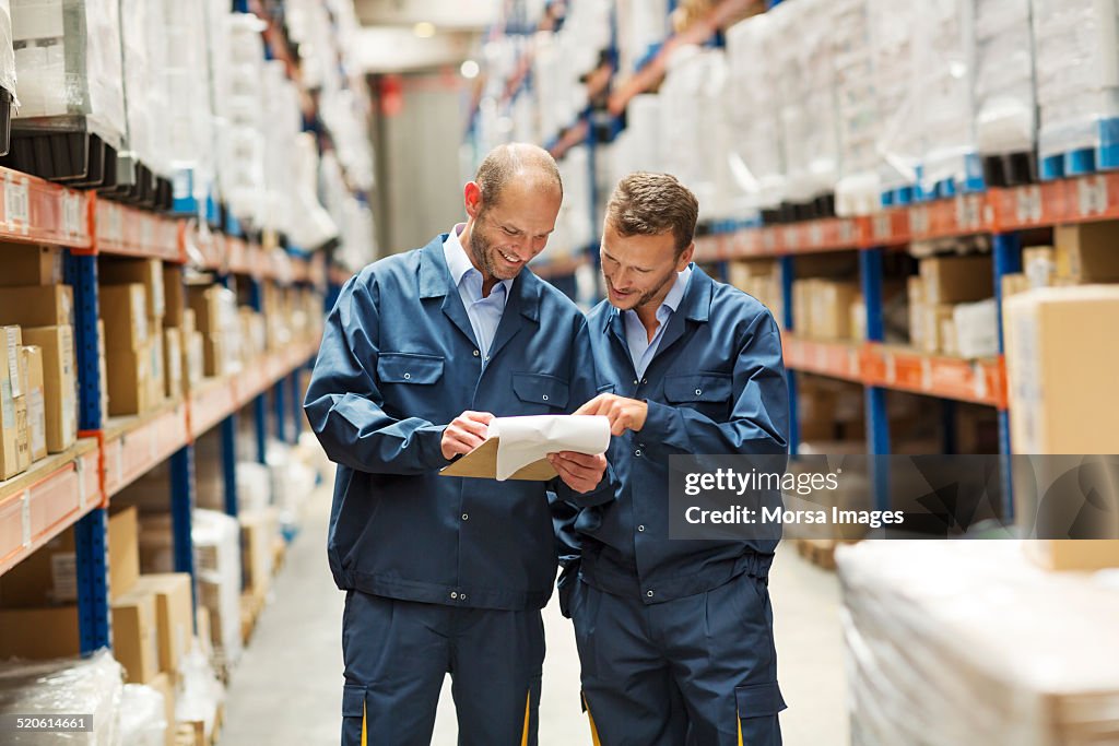 Workers discussing in warehouse