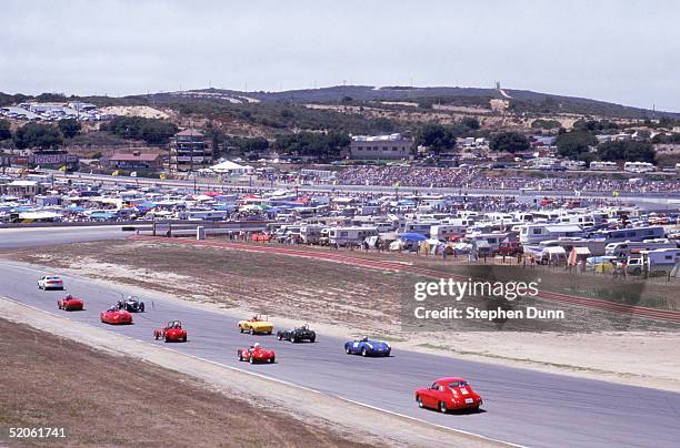 General view as vintage autos drive on the track at Laguna Seca Raceway during the Monterey Historic Automobile Races in August of 1991 in Monterey,...