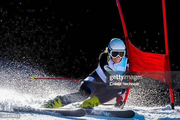 side view of young woman at giant slalom race - slalom stockfoto's en -beelden