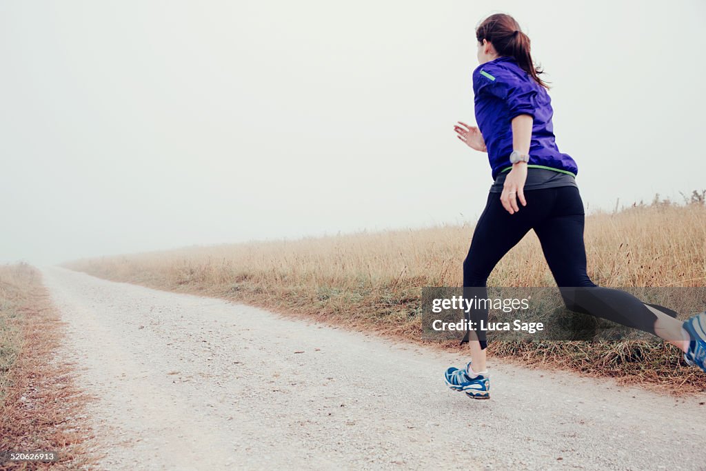 Female Runner Sprints In The Country