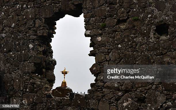 The Ryder Cup is viewed against the backdrop of the historic Dunluce Castle ruins as part of the Ryder Cup Trophy Tour launch on April 12, 2016 in...