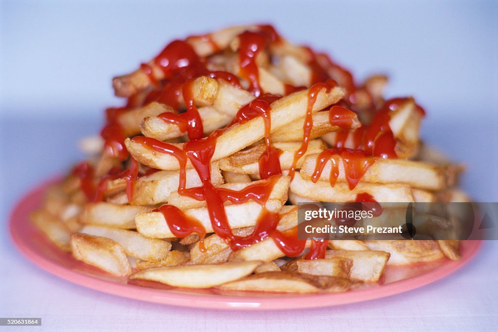 Plate of French Fries Smothered in Ketchup