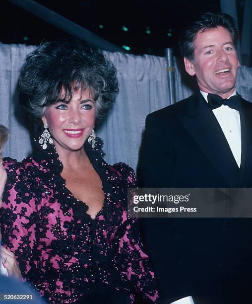 Elizabeth Taylor and Calvin Klein attends a reception of amfARs AIDS: To Care Is To Cure campaign at the Jacob Javits Center on April 29, 1986 in...