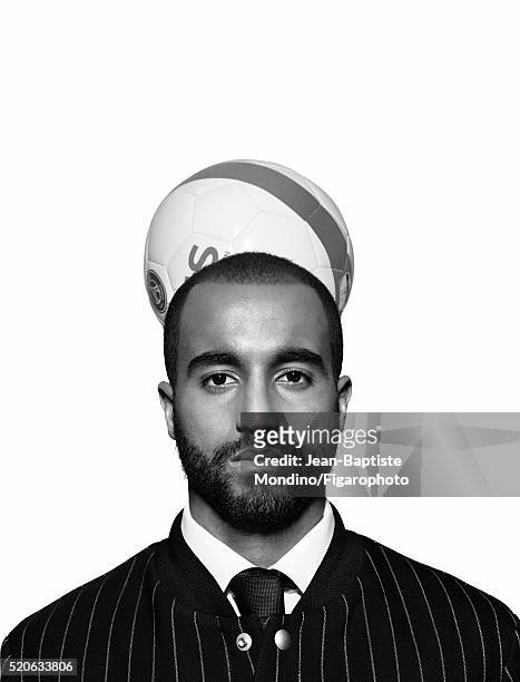 Soccer player Lucas Moura is photographed for Madame Figaro on February 24, 2016 in Paris, France. Jacket , shirt tie . Soccer ball . PUBLISHED...