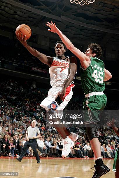 Kareem Rush of the Charlotte Bobcats gets up to the net as Raef LaFrentz of the Boston Celtics trys to block on January 25, 2005 at the Charlotte...