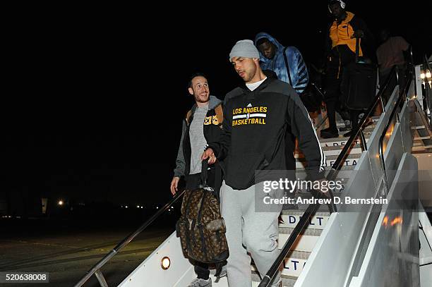 Marcelo Huertas and Robert Sacre of the Los Angeles Lakers exit the plane as they arrive in New Orleans, Louisiana from Inglewood, California on...