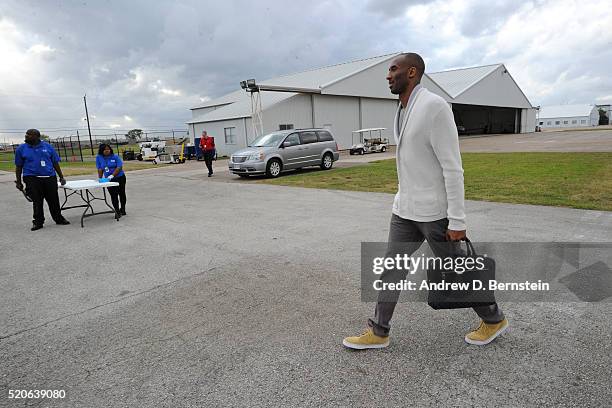 Kobe Bryant of the Los Angeles Lakers walks to the plane to travel to Oklahoma City, Oklahoma from Houston, Texas on April 10, 2016. NOTE TO USER:...