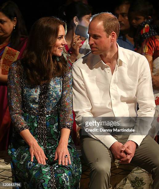 Catherine, Duchess of Cambridge and Prince William, Duke of Cambridge watch dancing by the fireside during a Bihu Festival Celebration at Diphlu...