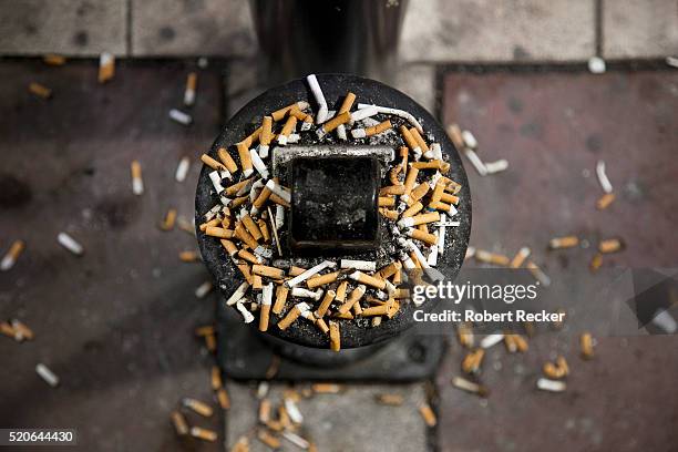 cigarette butts overflowing outdoor ashtray - stubs stock pictures, royalty-free photos & images