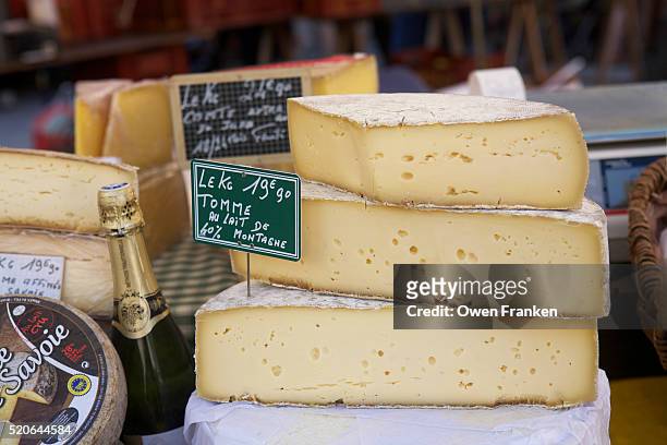 mountain cheese for sale in the beaune saturday market - beaune france stock pictures, royalty-free photos & images