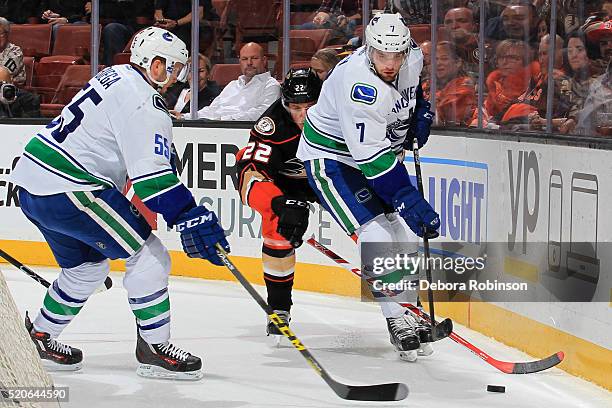 Linden Vey and Alex Biega of the Vancouver Canucks battle for the puck against against Shawn Horcoff of the Anaheim Ducks on April 1, 2016 at Honda...