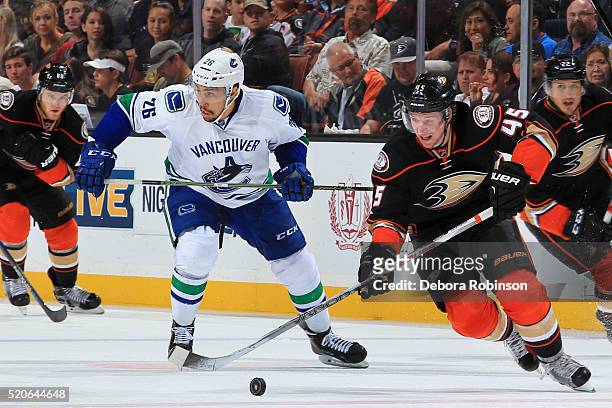 Sami Vatanen of the Anaheim Ducks skates with the puck against Emerson Etem of the Vancouver Canucks on April 1, 2016 at Honda Center in Anaheim,...