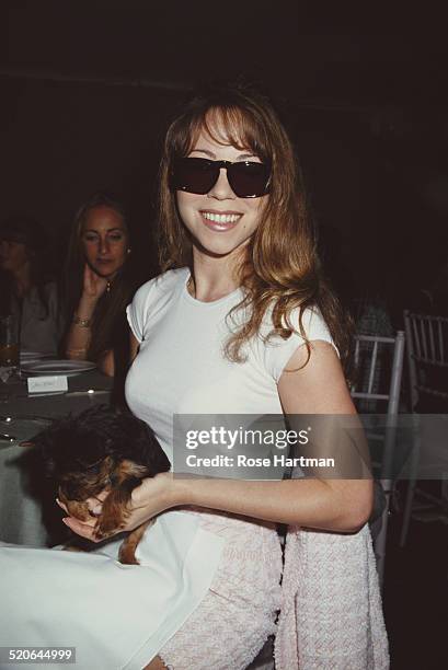 American singer, songwriter, and actress, Mariah Carey, at a Chanel lunch and fashion show to benefit a local hospital, New York City, USA, 1994.