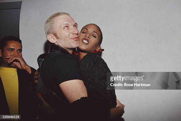 French fashion designer Jean Paul Gaultier and American actress and model Toukie Smith embrace at a private party in SoHo, New York City, USA, circa...