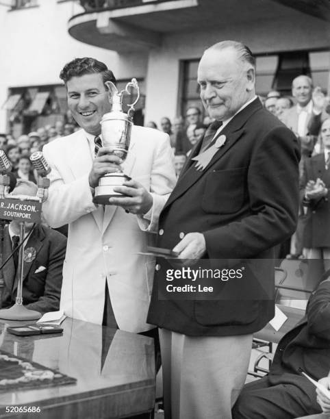 Australian golfer Peter Thomson receives the Open Golf Championship cup from S. T. L. Greer, Captain of the Royal Birkdale Golf Club at Southport,...