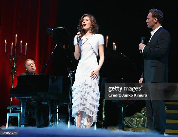 Actors Patrick Wilson and Emmy Rossum perform while Sir Andrew Lloyd Webber plays the piano, during the premiere for "The Phantom of the Opera"...