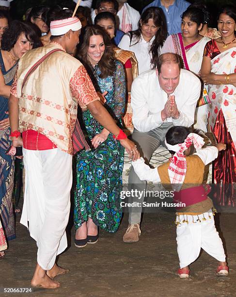 Prince William, Duke of Cambridge and Catherine, Duchess of Cambridge watch a young boy dance during a Bihu Festival Celebration at Diphlu River...