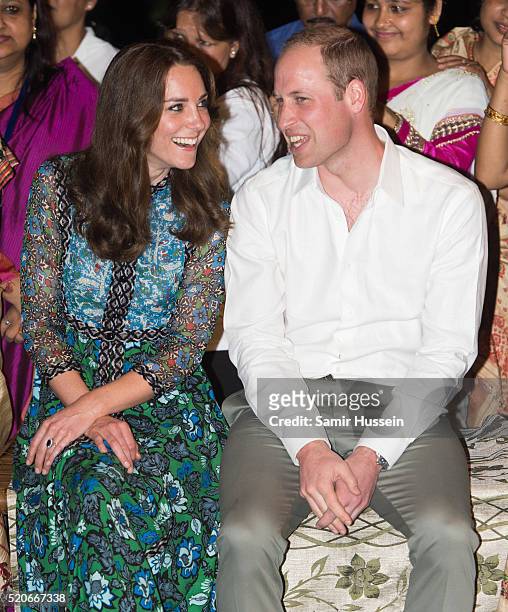 Prince William, Duke of Cambridge and Catherine, Duchess of Cambridge watch dancers by the fireside during a Bihu Festival Celebration at Diphlu...