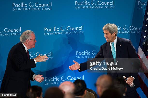 Former U.S. Ambassador to the United Kingdom Robert Tuttle shakes hands with United States Secretary of State John Kerry after Kerry addressed the...
